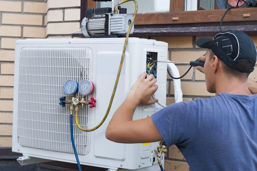 worker installs air conditioner