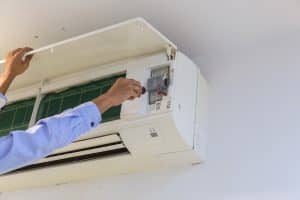 Technician repairing air conditioner